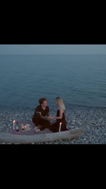 Romantic Couple Kissing Each Other and Having a Dinner Date on Rocky Shore