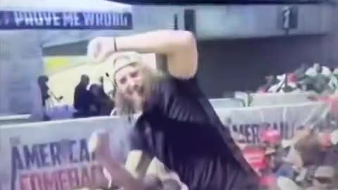 Who is this man who celebrates & perhaps signals to someone the assassination of Kirk?