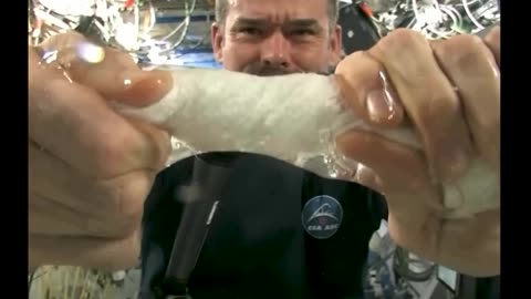 Squeezing wet towel in space 😲