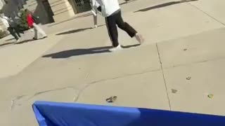 Student at University of Iowa flips over TPUSA table.