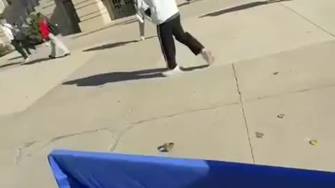 Student at University of Iowa flips over TPUSA table.