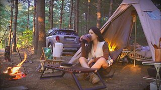 Cooking spicy braised chicken in a wood-burning stove in a pine forest