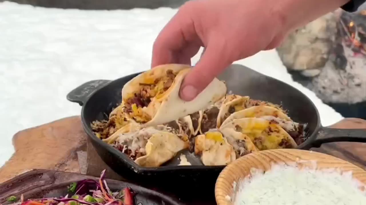 Making delicious Healthy meal while capming by the Natural Waterfall in snow weather