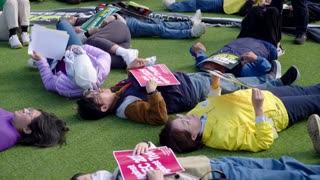 Dozens 'play dead' to protest capitalism and Trump as APEC ends