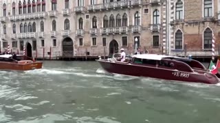 Jeff Bezos waves to onlookers as he heads to wedding gala