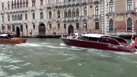 Jeff Bezos waves to onlookers as he heads to wedding gala