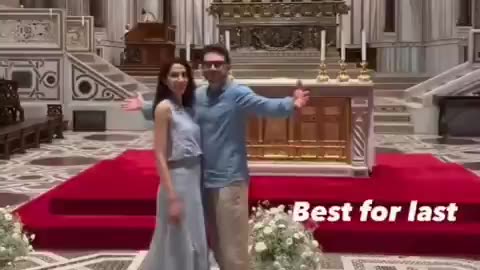 Alex Soros is seen mocking the crucifixion pose of Christ, arms out and head
