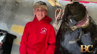 Teen fishing off New England coast catches huge halibut bigger than him