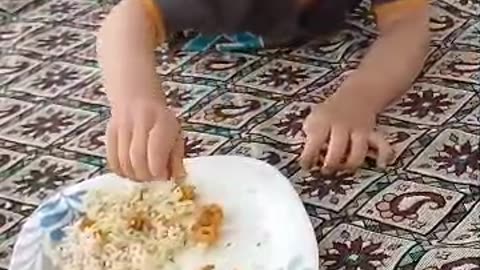 Radmehr, a cute boy who loves shrimp, is lying down and eating shrimp.