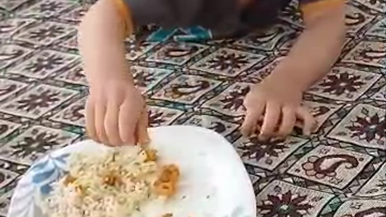 Radmehr, a cute boy who loves shrimp, is lying down and eating shrimp.