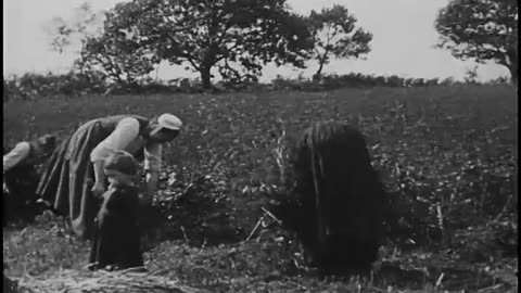 The Penn at sea, other ships surrounding ships ahead of Penn and behind guns on ship