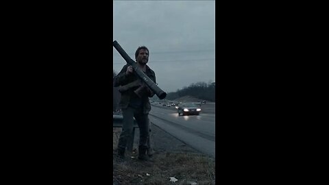 Man with bazooka firing at cars on the highway
