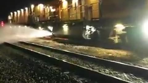 A powerful maintenance train cleaning and reshaping the rail head