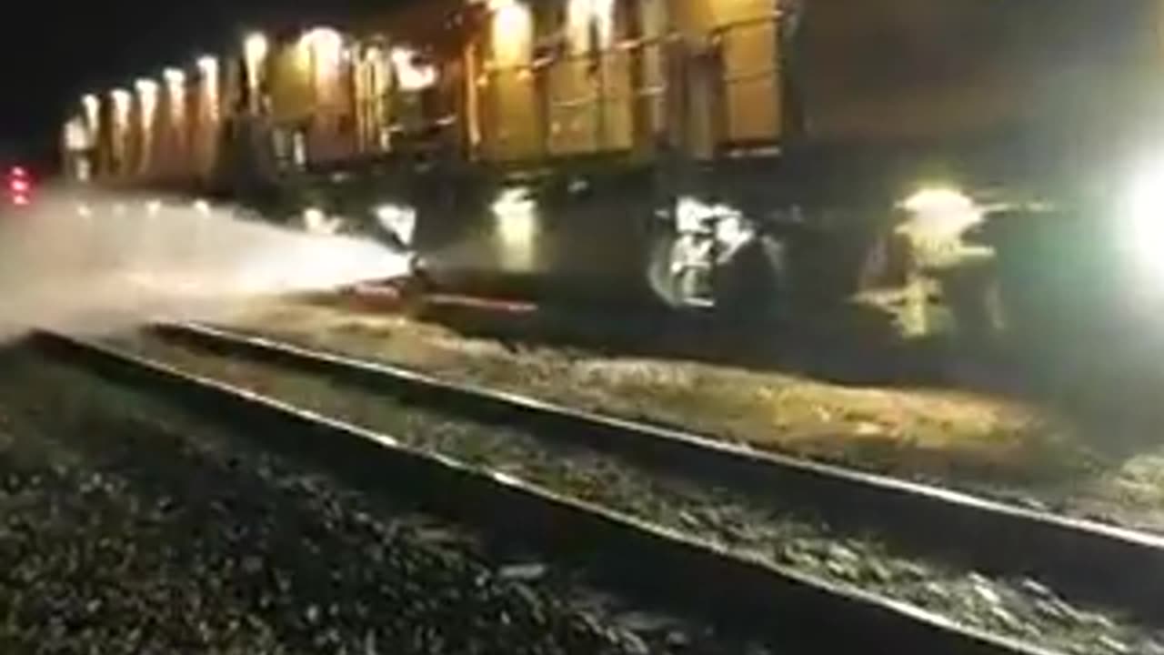 A powerful maintenance train cleaning and reshaping the rail head