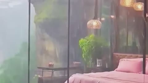 Cliffside Glass Resort Bedroom with Rainfall Views.
