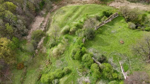 Mitford castle Northumberland drone flight along river and ruins