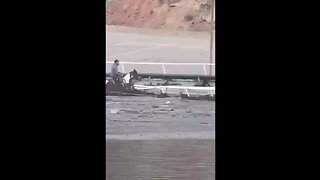 Locals capture Insane footage of man riding horse in dangerous flood waters to free other horses