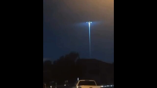Residents observed an unidentified flying object in the sky, emitting a large beam