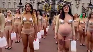 Women imitate cows in a protest against dairy cruelty in front of Buckingham Palace, London