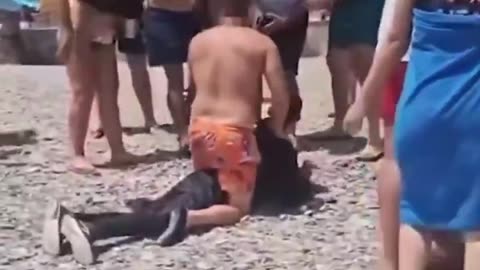 Dozens of boat migrants were tackled and detained by beachgoers after landing in Spain