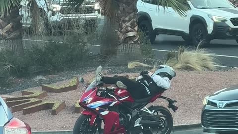 Motorcyclist Relaxes at Stoplight