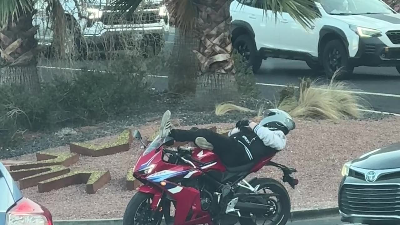 Motorcyclist Relaxes at Stoplight
