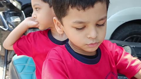 How about this caption: "Brothers on a roll—ready for their next adventure! 🛵"