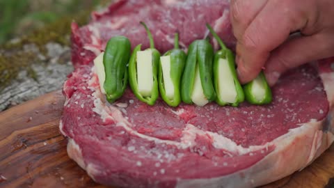 Stuffed Tomahawk Steak with Cheese Cooked in the Forest