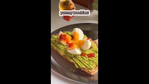 High protein breakfast bread with avocado and boiled eggs with chili oil sauce, and kiwi yogurt