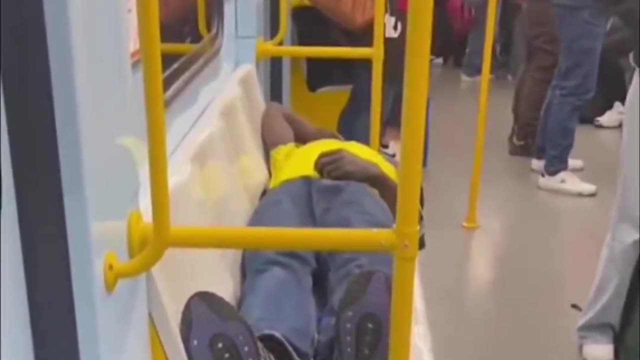 This is Milan 2025. A migrant disrespectfully blocks the seats and Italians stand.