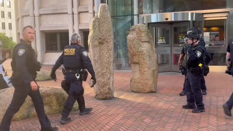 A Seattle Antifa rioter attacking a federal building with large rocks manages to escape on foot.