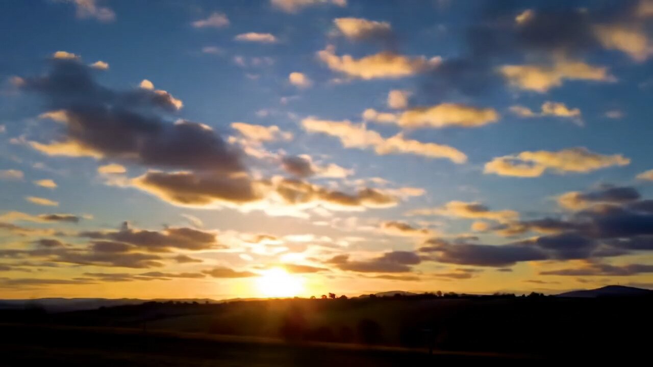 Breathtaking Sunset Over Rolling Hills – A Serene Evening Sky