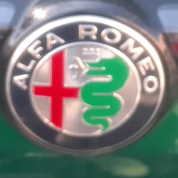 ALFA ROMEO DOG SERPENT EATING A MAN AND THE GEORGE GENOA GENOCIDE FLAG TRUTH IN PLAIN SIGHT
