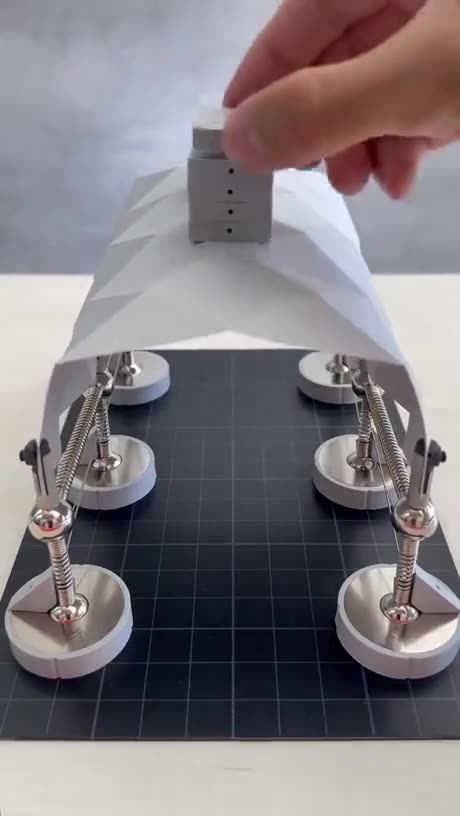 A demonstration of how folded plate designs influences the strength of shell structures.