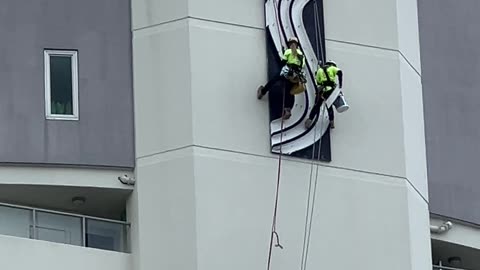 Rope Access Techs Descend Towering Sentinel Building for High-Altitude Sign Maintenance
