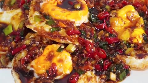 Fried eggs in spicy chili sauce