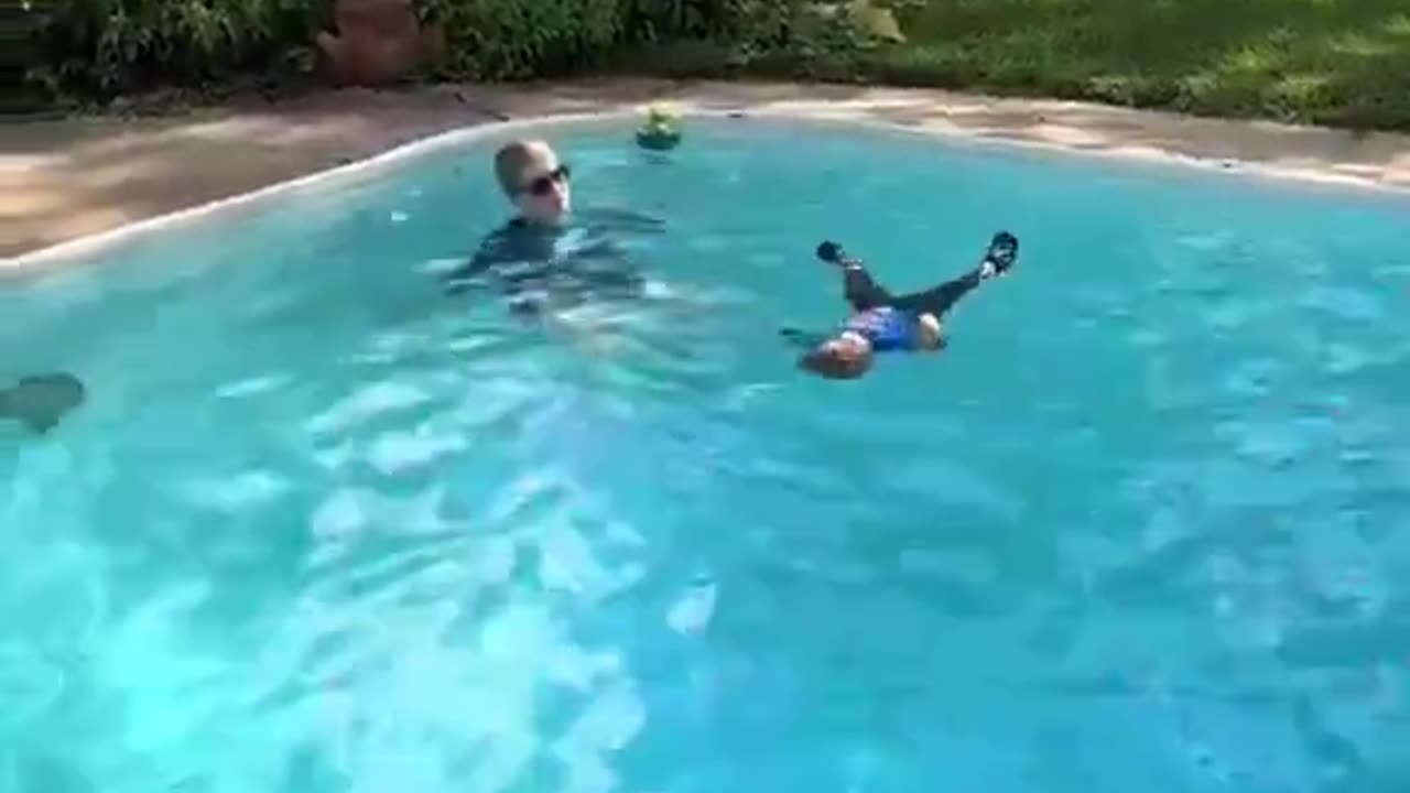 This is good parenting. Mum teaching the kid to swim.