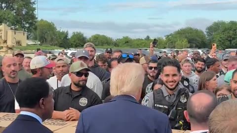 President Trump shakes hands with law enforcement over boxes of Pizza