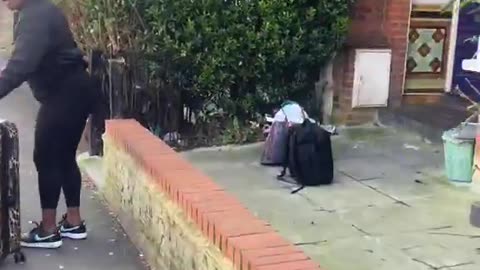 An irate Black woman confronts a white woman with her young child in London.