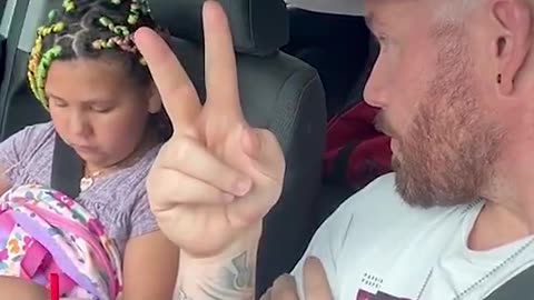 Daddy doing the right thing! She does not look happy