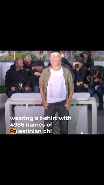 Julian Assange at Cannes Film Festival, displaying the names of 4,986 Palestinian children murdered in Gaza by Israel
