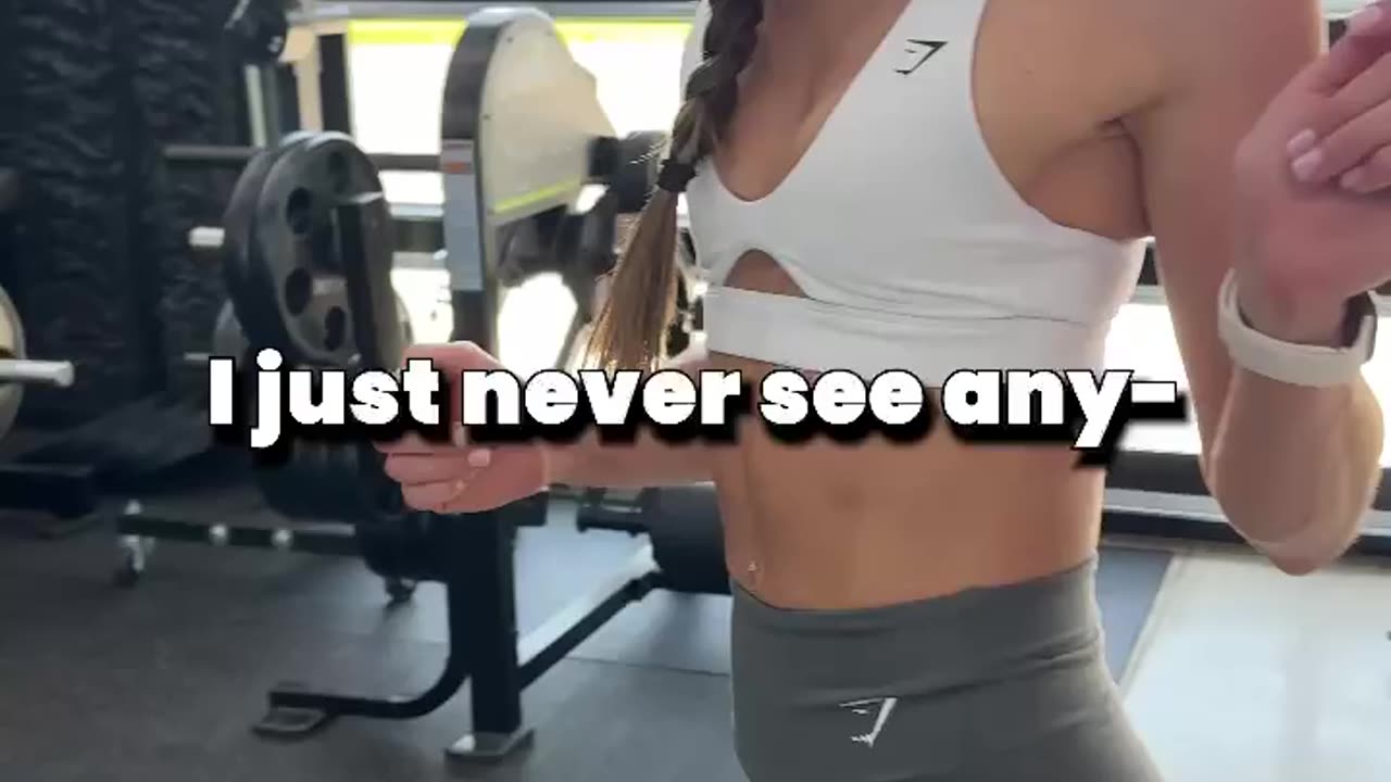 Girl lifting weights and her trainer 2