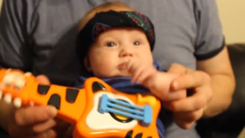 Cutest metal band video ever! Baby plays air guitar like a boss!