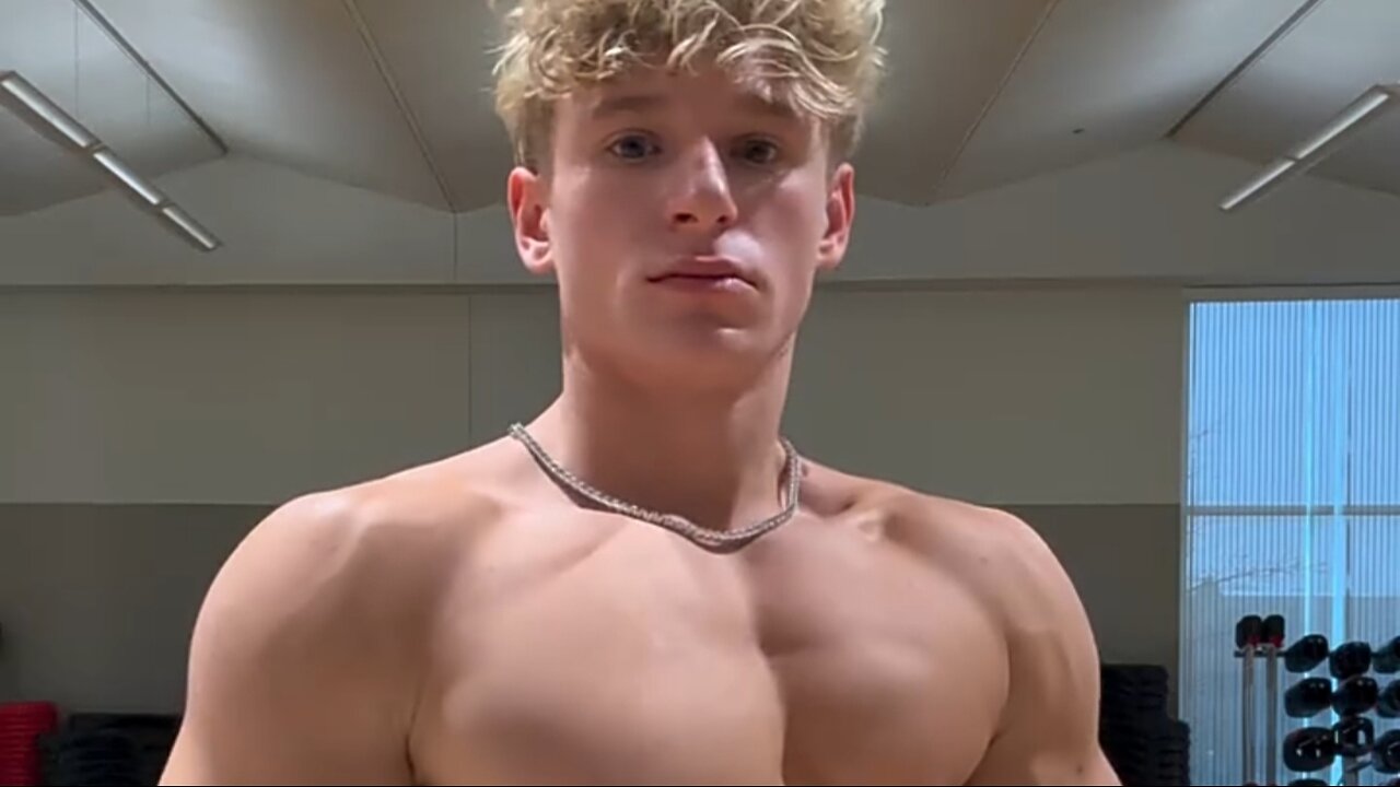 Young aesthetic bodybuilder flexing muscles