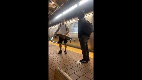 NYC - A man defends himself from a potential knife attack with a skateboard.