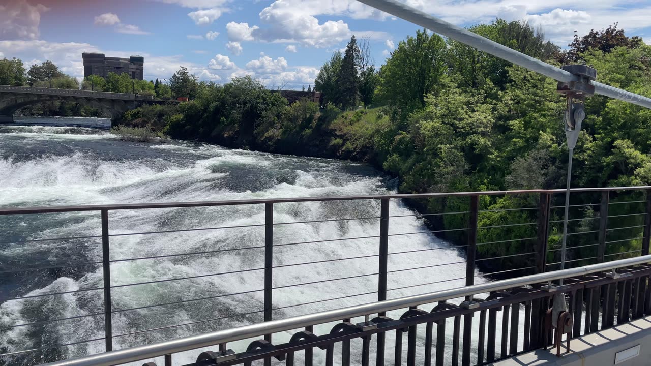Spokane falls, on a bridge at a high point over Spokane falls with the surrounding skyline