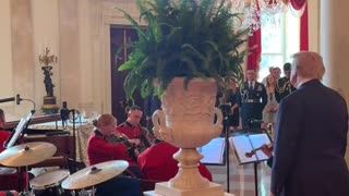 President Donald J. Trump stops to watch the United States Marine Band play God Bless America