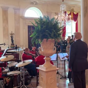 President Donald J. Trump stops to watch the United States Marine Band play God Bless America