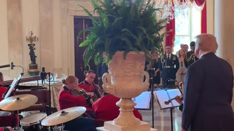 President Donald J. Trump stops to watch the United States Marine Band play God Bless America