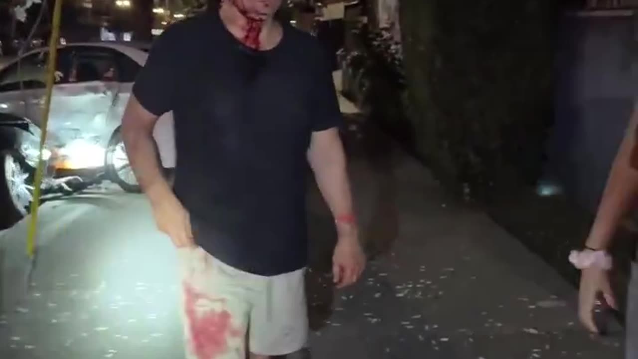 A drunk driver drove through a red light when two pedestrians were crossing the street.